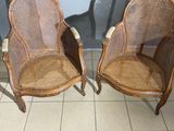 pair of wicker chairs in the shape of a chair