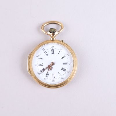 a gold pocket watch with roman numerals on the face