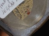 someone is holding a glass jar with a label on it