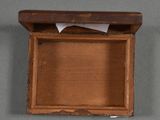 an old wooden box with a piece of paper sticking out of it