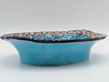 small blue bowl with a floral design on the rim