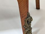 a close up of a wooden table with a flower on it