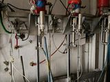 a room with a bunch of water tanks and a bucket