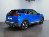 the rear end of a blue suv parked in a garage