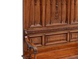 a wooden bench with a carved back and a bench seat