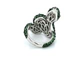 an image of a ring with green stones in it on a white surface