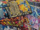 many pokemon cards are scattered on a table in a room