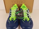 a pair of blue and green sneakers with a box in the background