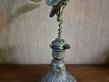 a statue of a bird on top of a pedestal