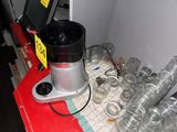 a blender that is sitting on a counter next to many cups