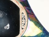 a close up of a colorful vase with a mouse on it