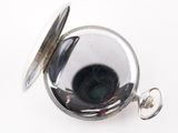 a silver pocket watch with a black face on it
