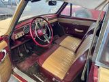 a red car with a tan leather seat and dashboard