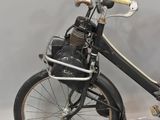 a small black bike with a basket on the back of it