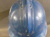 a blue helmet that is on display in a glass case
