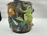 a mug with a frog on it sitting on a table