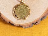a close up of a coin on a piece of wood