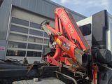 a red crane that is sitting on the back of a truck