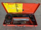 an open tool box with tools inside of it on a concrete floor