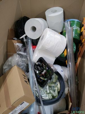 a cardboard box filled with toilet paper, toilet paper rolls, and other items