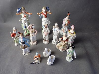 many figurines of people that are sitting on a table