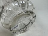 a glass jar with a label on it sitting on a table