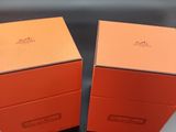 two orange boxes sitting on top of a table next to each other