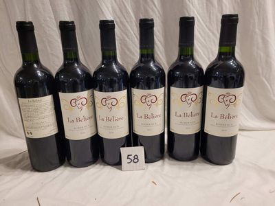 six bottles of red wine are lined up on a table