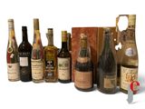 bottles of wine are lined up in a row on a white surface