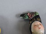 two figurines that are sitting next to each other on a table