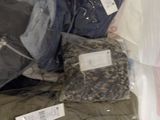 a lot of clothes that are in a plastic bag