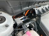a close up of a car ' s engine with its hood open