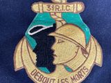 navy officer ' s badge on a blue jacket with a gold anchor