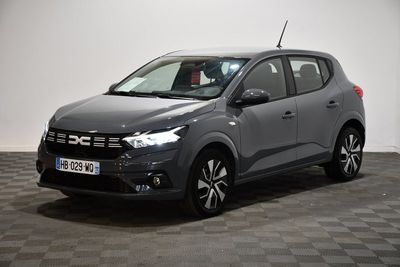the grey car is parked on a checkered floor in a room