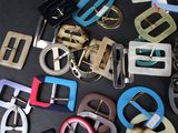 a lot of different colored belts on a black surface
