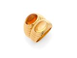 a gold ring with an oval stone and a wavy band