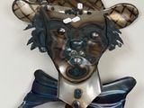 a metal sculpture of a bear with a bow tie