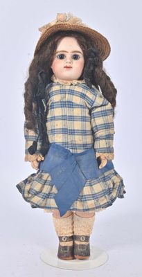 a doll that is wearing a hat and dress