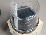 a glass container with a black substance inside of it