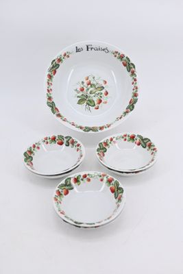 four plates with strawberry designs are arranged on a white surface