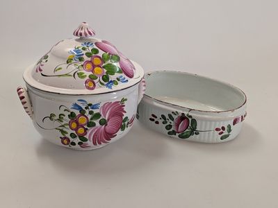 a white bowl with a lid and a bowl with flowers on it