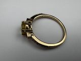 a close up of a gold ring with a diamond on it