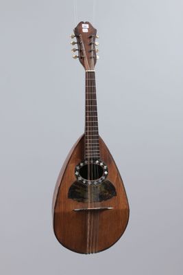 an image of a mandolin hanging from a string on a wall