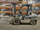 a forklift truck that is parked in a warehouse
