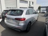the rear end of a silver car parked in a parking lot