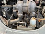a close up view of a car engine with the hood open
