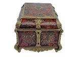 a red and gold box sitting on top of a white surface