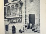 an old black and white photo of a group of people in front of a building