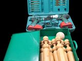 a green box with a bunch of wooden toys inside of it