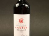 a bottle of red wine that is sitting on a table